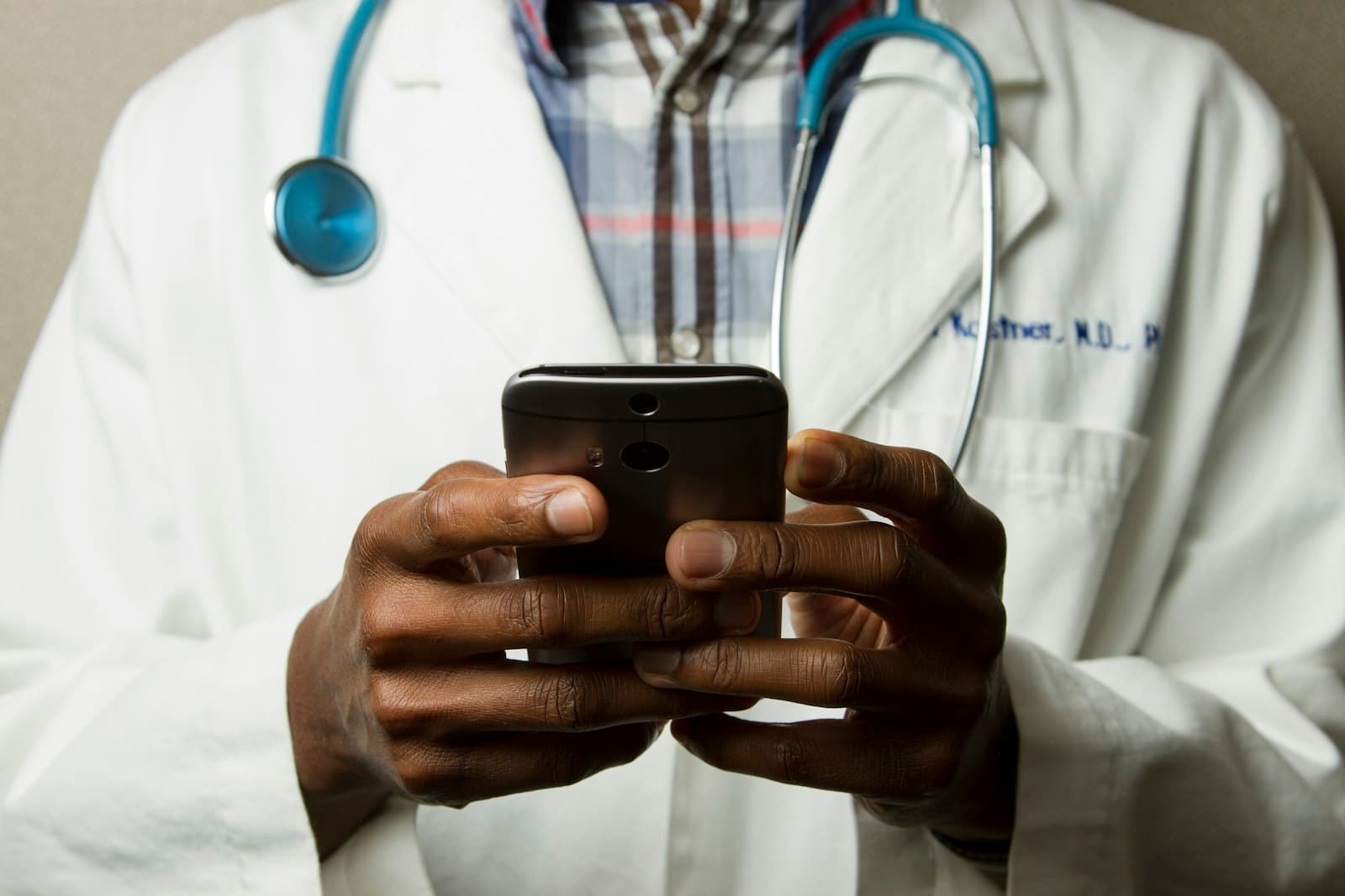 Clinician using a mobile device at a hospital to support patient care